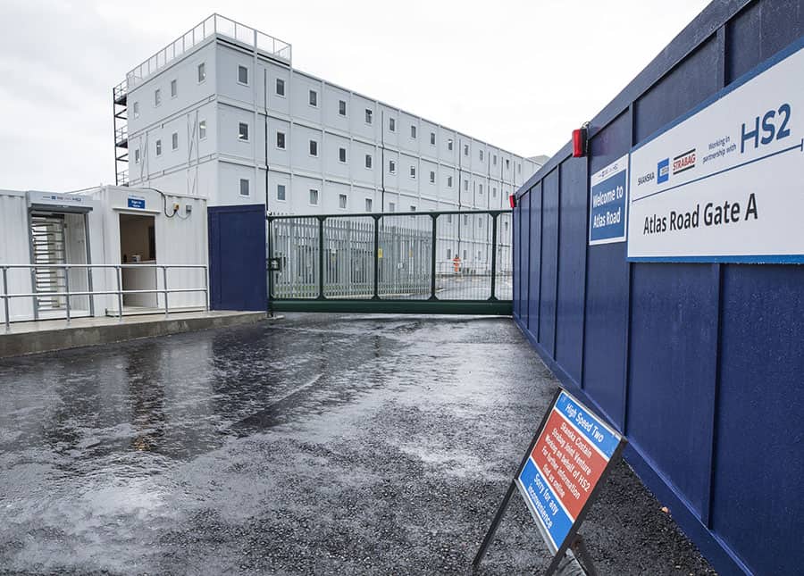 Temporary Modular building built for HS2. Outside view of the white modular units, surrounded by a gate. 