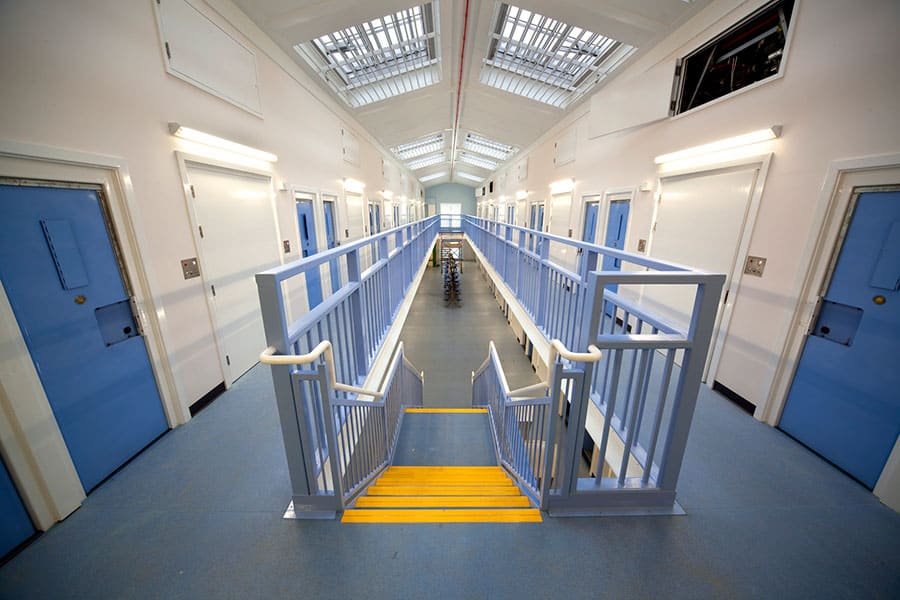 Modular Building built for prison use. Lot's of cell doors, with a stairwell in the middle.