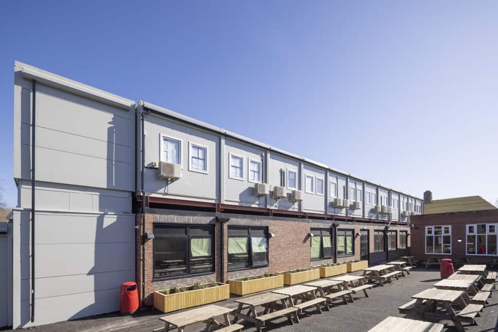 Outside view of two-storey modular building, constructed offsite. Temporary classrooms.