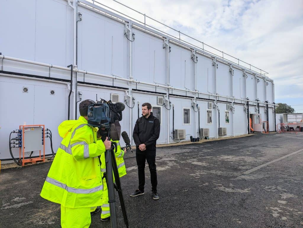 Premier Modular Apprentice getting interviewed by the BBC in front of temporary modular units built during his apprenticeship. 