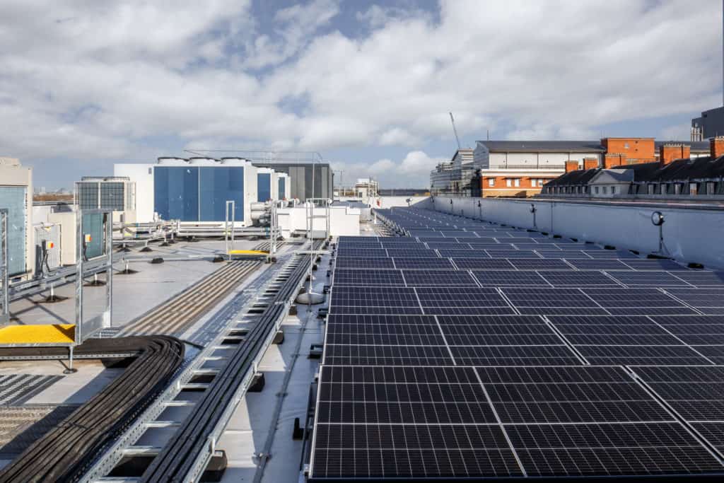 Several solar panels, attached to the roof of the hospital to make healthcare more sustainable.