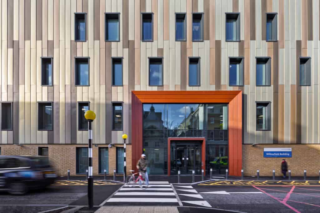 Outside view of Kings College Hospital, Modular Healthcare Building. Zebra crossing leading up o the entrance, with big glass doors. 