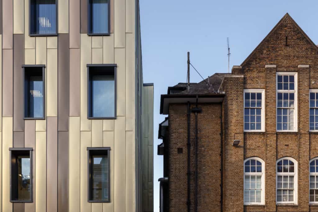 Zoomed in view of the side of a building stood next to new modular medical building for Kings College Hospital.