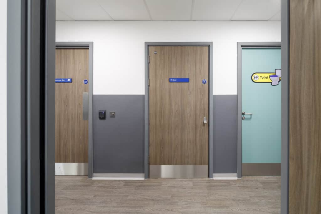 3 doors, rooms inside a modular healthcare building.