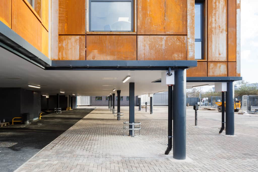 Close up of underneath Leeds City College new modular building. The building was built onto podiums to allow for parking spaces beneath the modular classrooms.