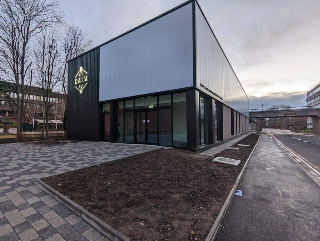 Modular two-storey facility for Hull University, outside view. Grey and black walls, with windows surrounding the first storey.