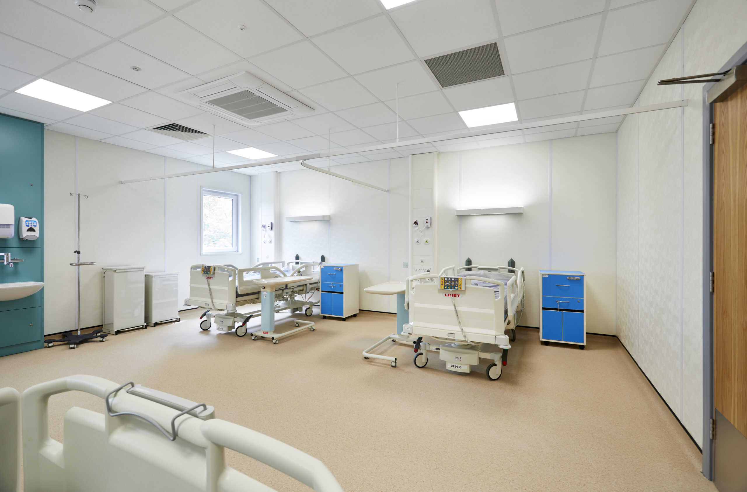 Modular hospital room completed for Dorset County Hospital. 2 Hospital beds alongside cabinets and hosital equipment. 