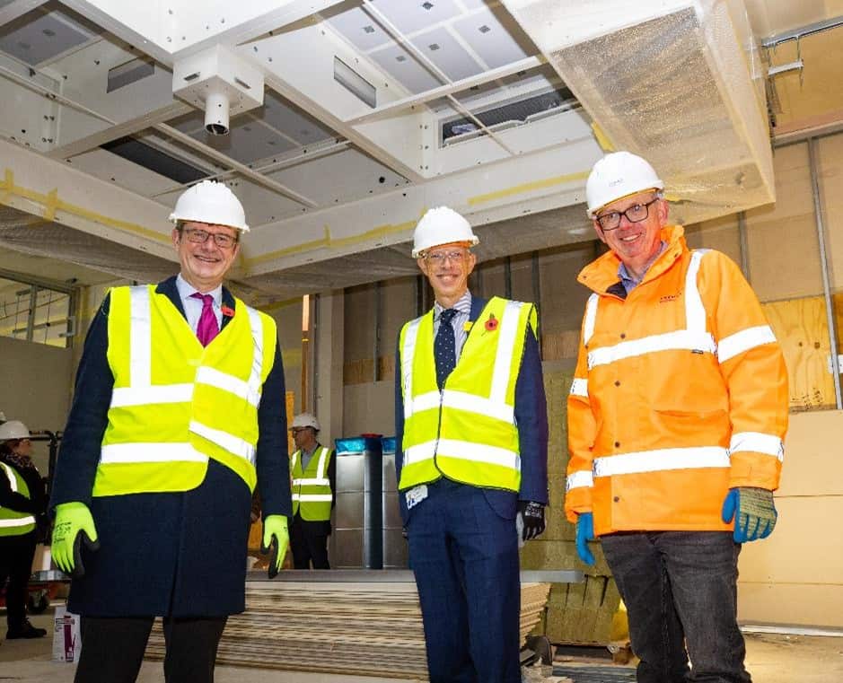 Three members of the Premier Modular team, wearing high vis jackets and hard hats, ready for offsite construction to take place.