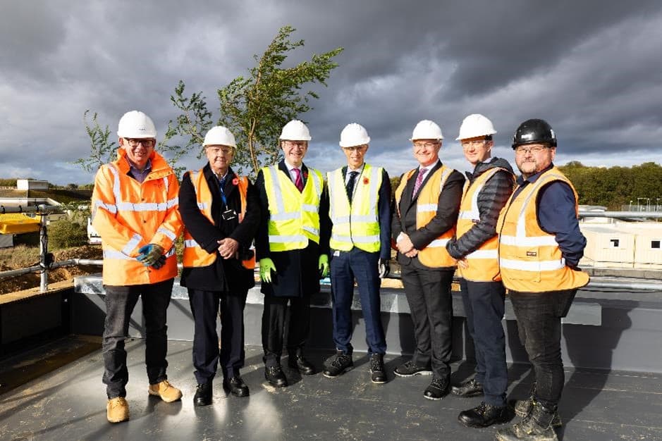 Seven members of the team wearing high vis jackets and hard hats. Ready for modular construction to commence.