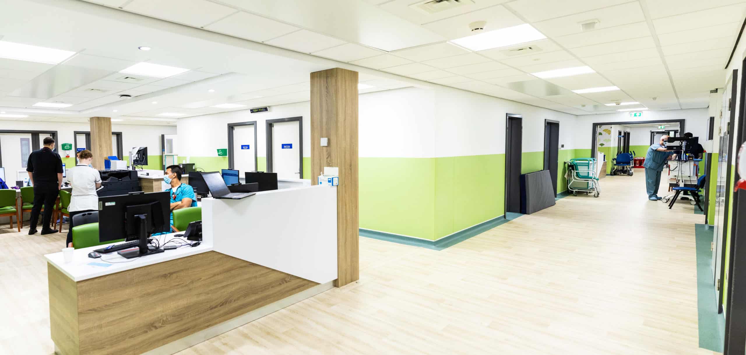 Modular hospital building completed through offsite construction. View of the reception and waiting area, as well as the corridor into treatment rooms. 