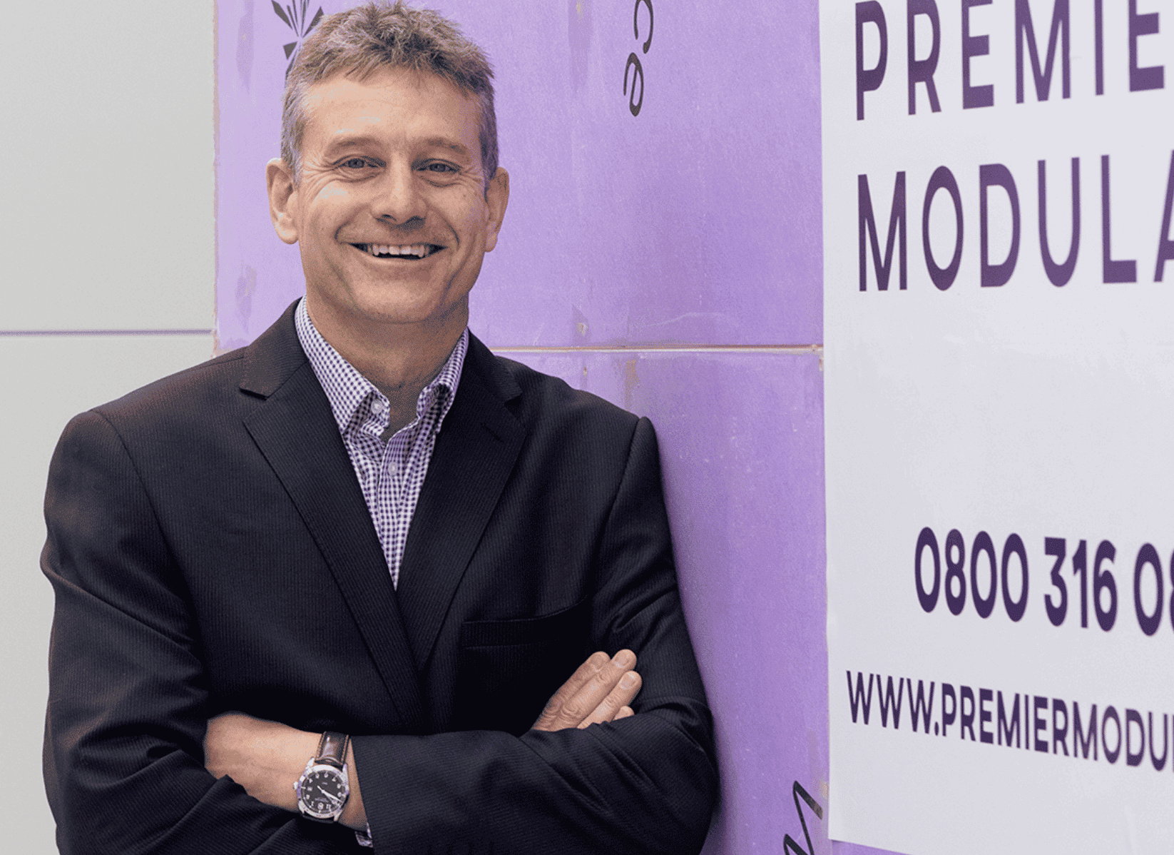 Premier Modular Groups CEO, David Harris. Man wearing a suit with arms folded. 