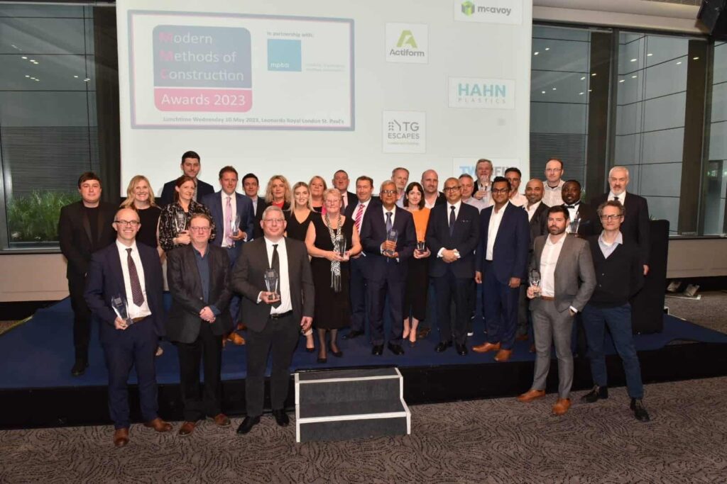 Premier Modular team collecting award for modular construction specialists