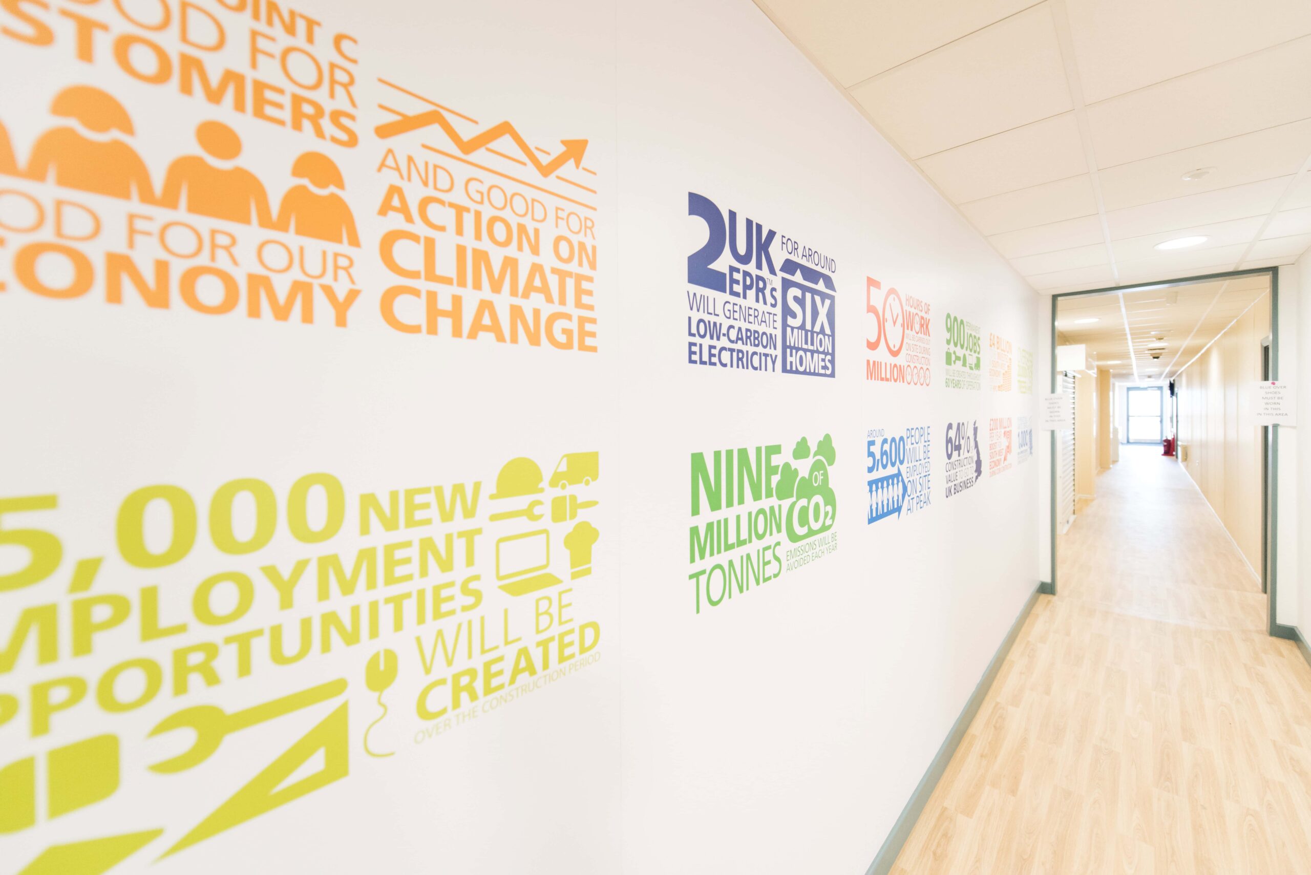 Wall with coloured writing on, inside a modular building. 