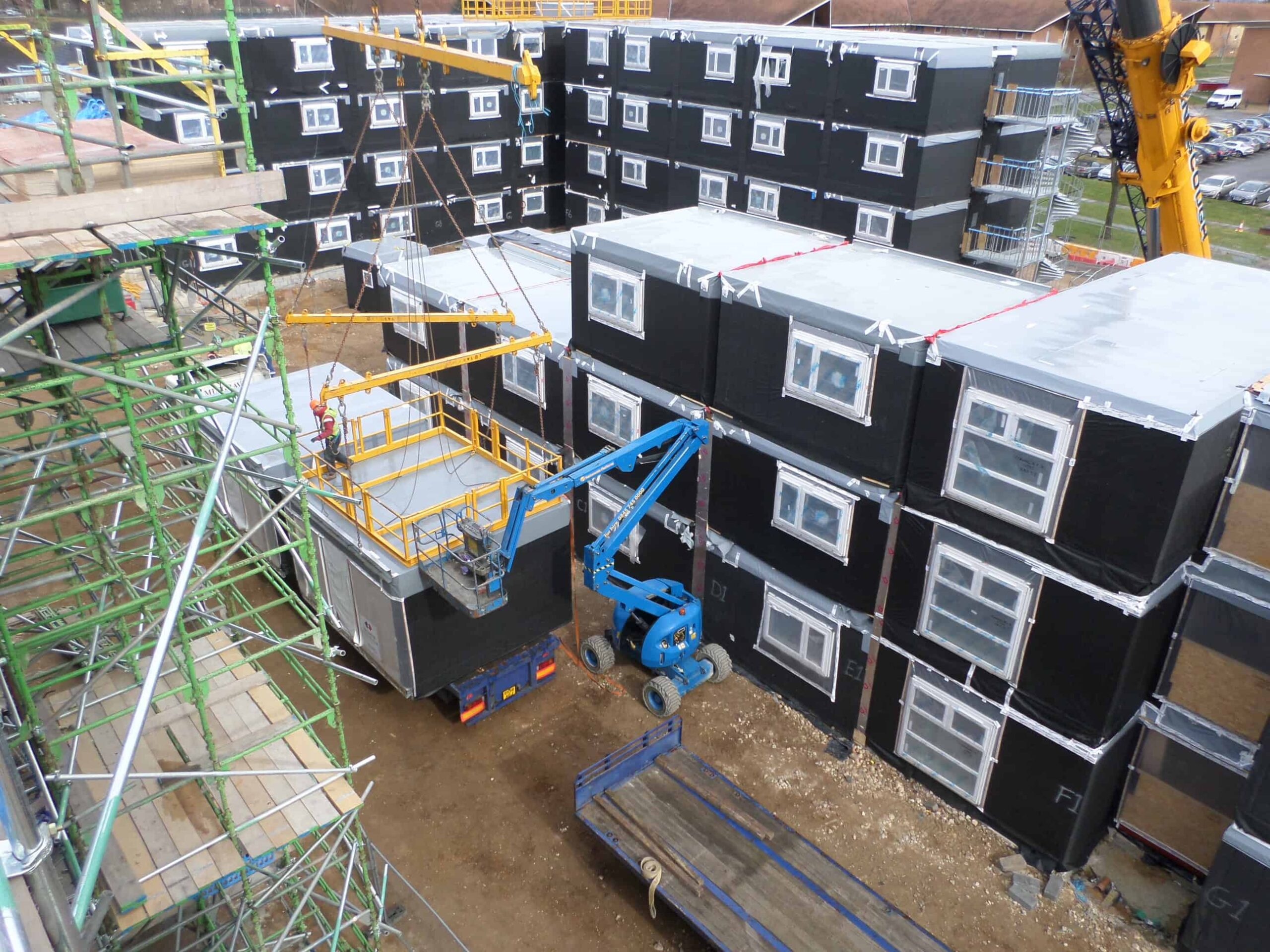 The modular building in construction. Placing the modular units on top of each other on site. 